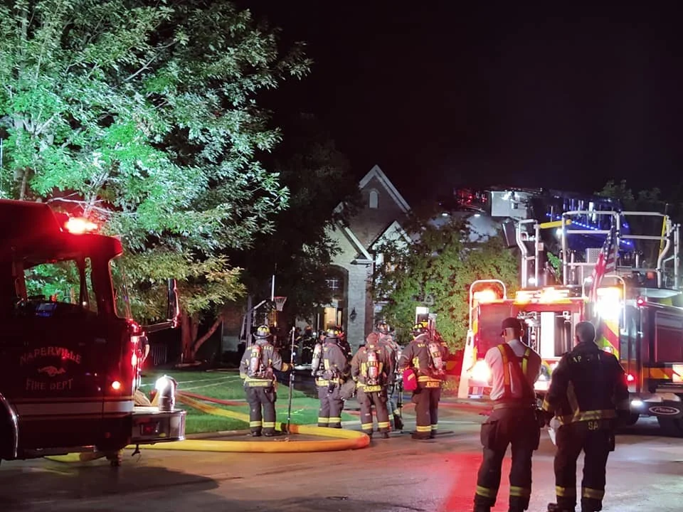 Fire crews and apparatus at a nighttime incident
